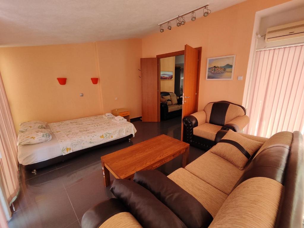 a living room with a couch and a bed at Apartment Crocus of Rafailovici in Budva