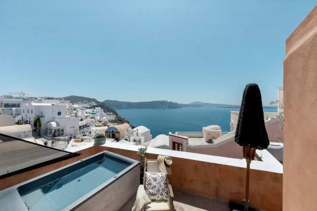 a view from the balcony of a house with a swimming pool at Όμορφη βίλα στην Οία με θέα στην καλντέρα in Oia