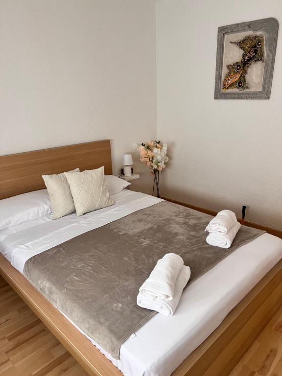 a bedroom with a large bed with two towels on it at Ca La Noa 2 in Viladecáns