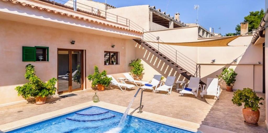 a villa with a swimming pool and a house at Casa Padrins de ses tanques in Ariany