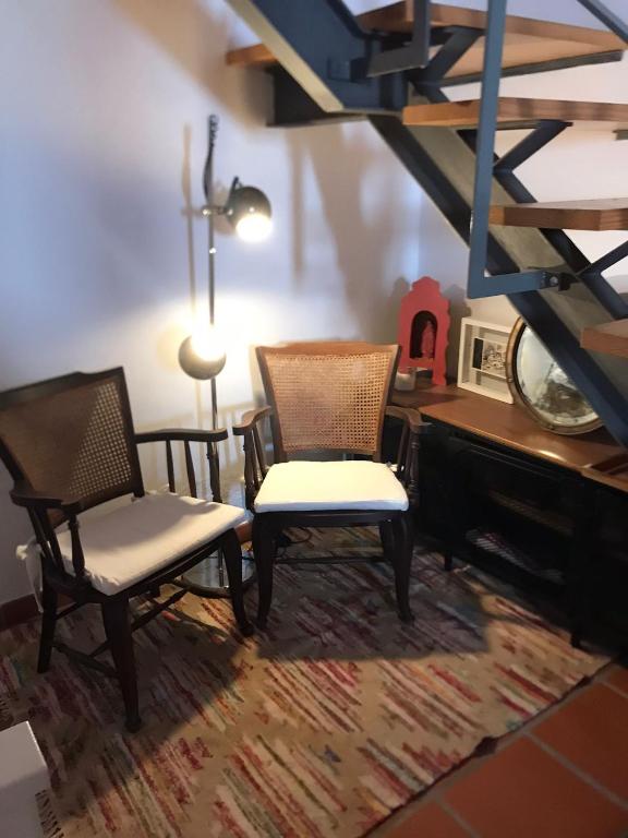 two chairs and a desk in a room at Casa do Mercador by Portus Alacer in Avis
