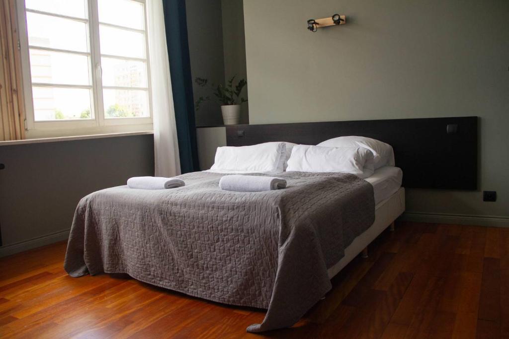 a bedroom with a bed with two towels on it at Open Doors Villa in Gdańsk