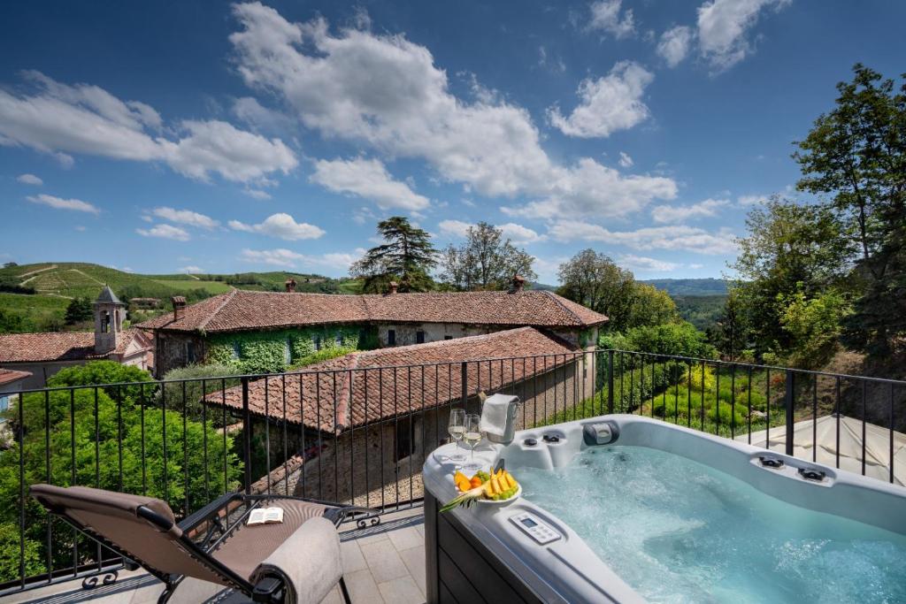 a hot tub on the balcony of a house at Centro Storico in Neviglie