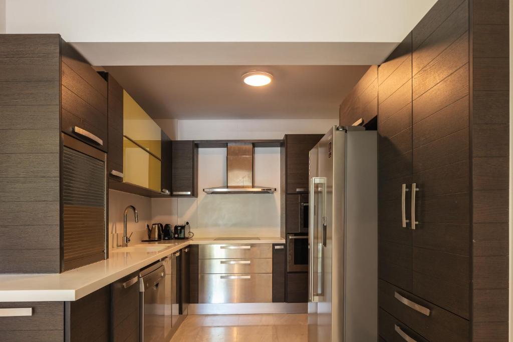 a kitchen with wooden cabinets and a kitchen island at Angels Villa in Kambánion