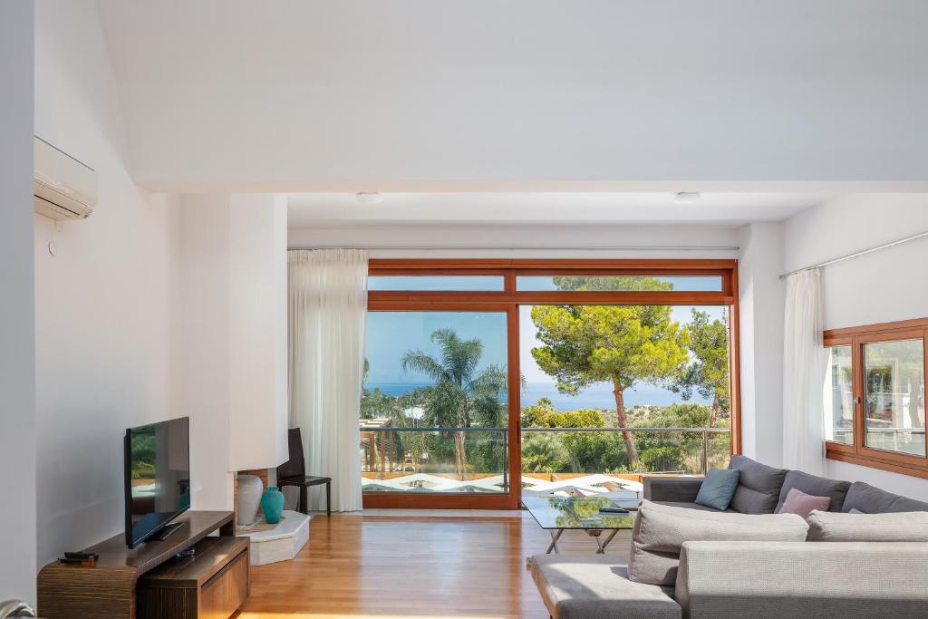 a living room with a couch and a television at Angels Villa in Kambánion