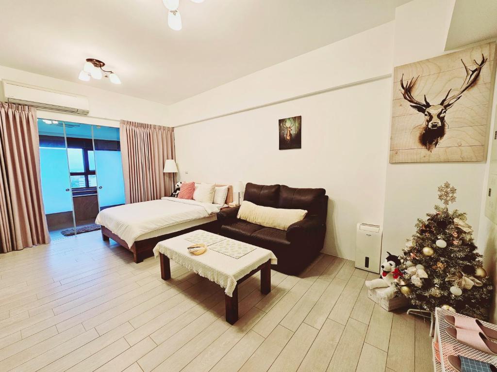 a living room with a christmas tree and a couch at 文旅海景 in Toucheng
