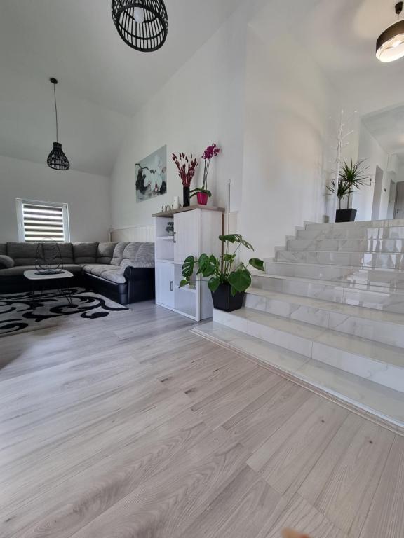 a living room with stairs and a couch at Kuća za odmor Family Ferlin in Grabrovnik