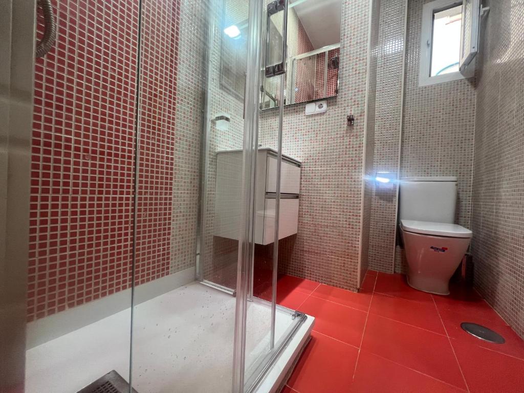 a bathroom with a glass shower and a toilet at Retiro, Atocha, Paseo del Prado. Pacifico Madrid 28007. in Madrid