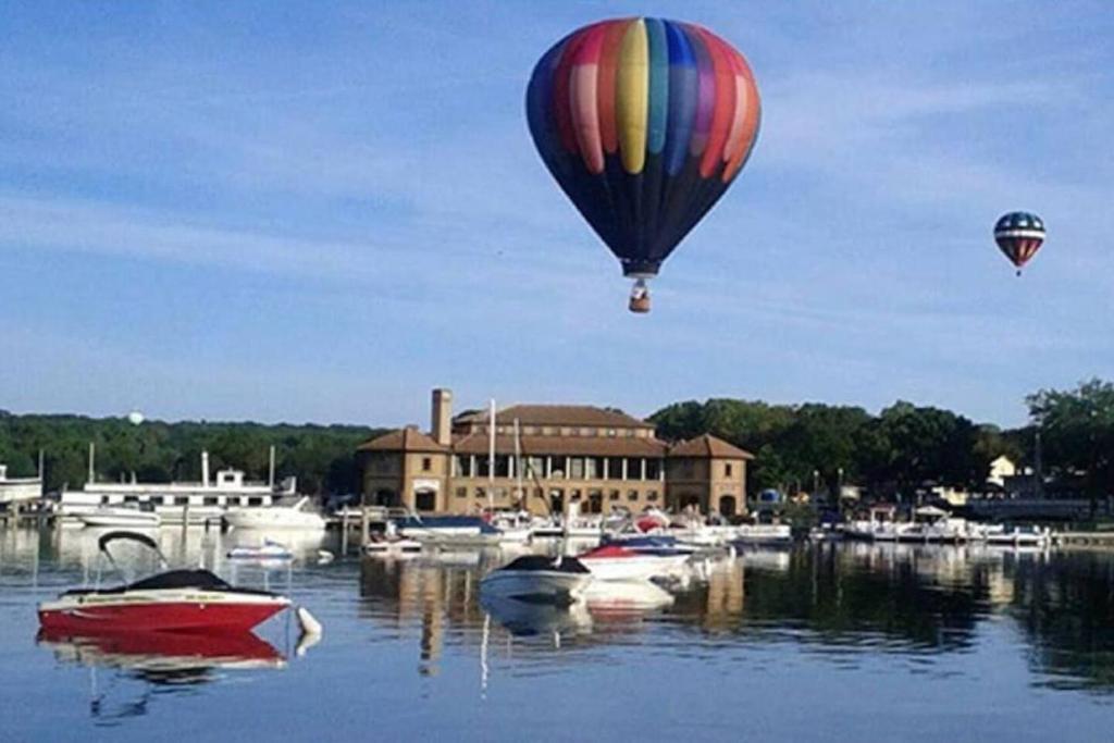 a hot air balloon flying over a marina with boats at Early check in- late check out Free day! in Lake Geneva