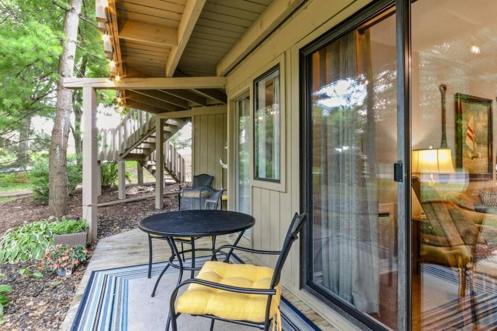 a screened porch with a table and chairs on it at Early check in- late check out Free day! in Lake Geneva