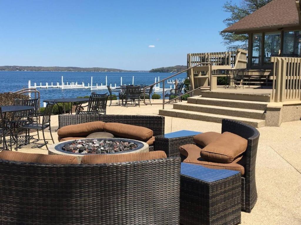 a patio with wicker chairs and a fire pit at Early check in- late check out Free day! in Lake Geneva