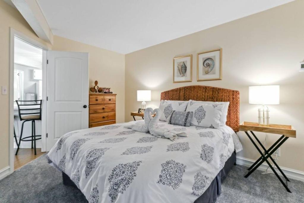 a bedroom with a bed and a table and a chair at Early check in- late check out Free day! in Lake Geneva