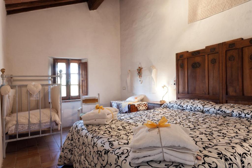 a bedroom with two beds with towels on them at VILLA DI GRAZIELLA in Montisi