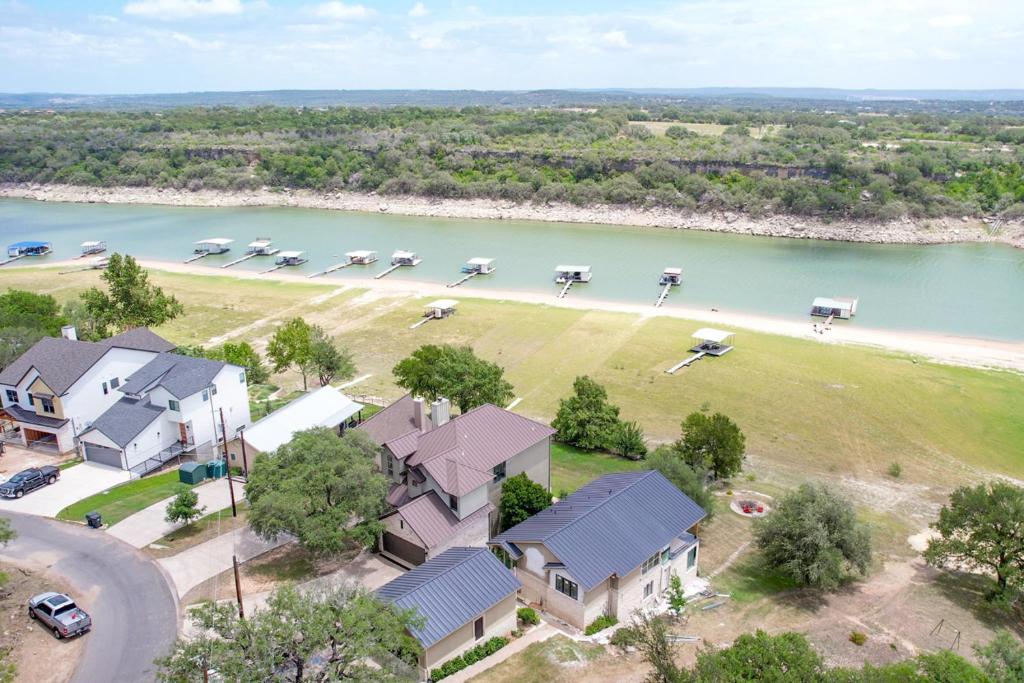 an aerial view of a house with boats in the water at Luxury Lakefront Home-Private Dock - Dipping Pool! in Spicewood