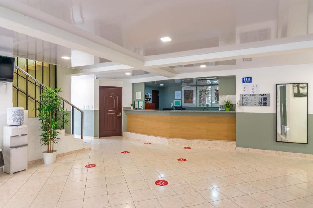a lobby with a counter in a hospital with red circles on the floor at Apartamentos in Condo Plaza Europa in Sosúa