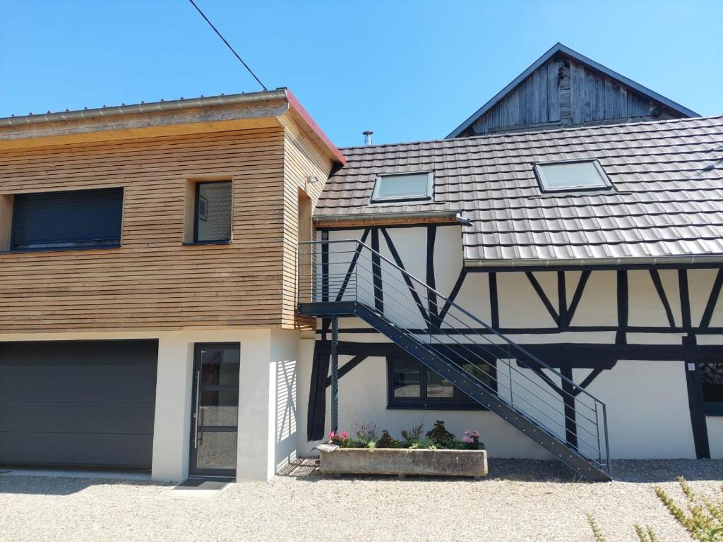 a house with a staircase on the side of it at La grange d'Auguste in Jettingen