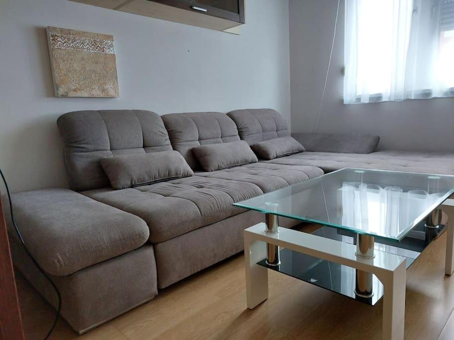 a living room with a couch and a glass table at Erzsebet Apartman, free parking in Budapest
