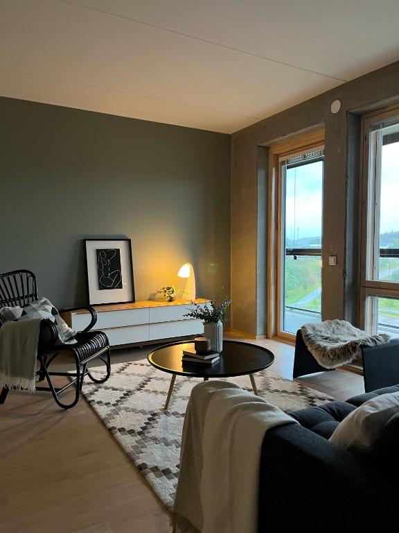 a living room with a couch and a table at Tikka Apartments in Jyväskylä