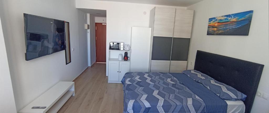 a small bedroom with a bed and a tv at Buenavista Estudio Torremolinos in Torremolinos