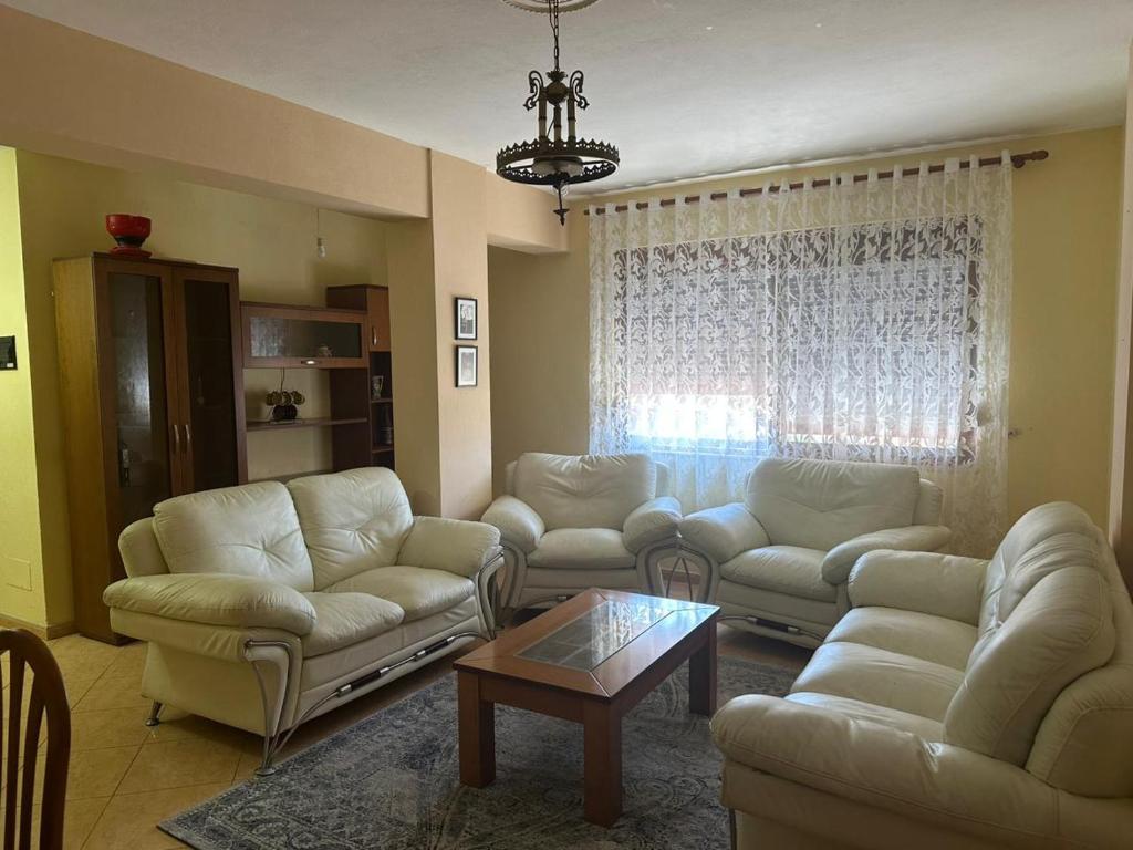 a living room with couches and a coffee table at Apartment City Center Best Price in Fier