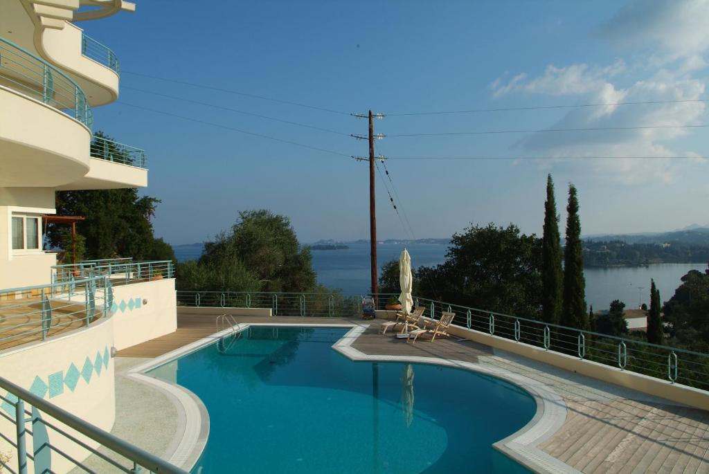 a swimming pool on the side of a building at Liberty - Classic luxury sea view villa with private pool, Panoramic views to Kommeno & Corfu old Town in Kommeno