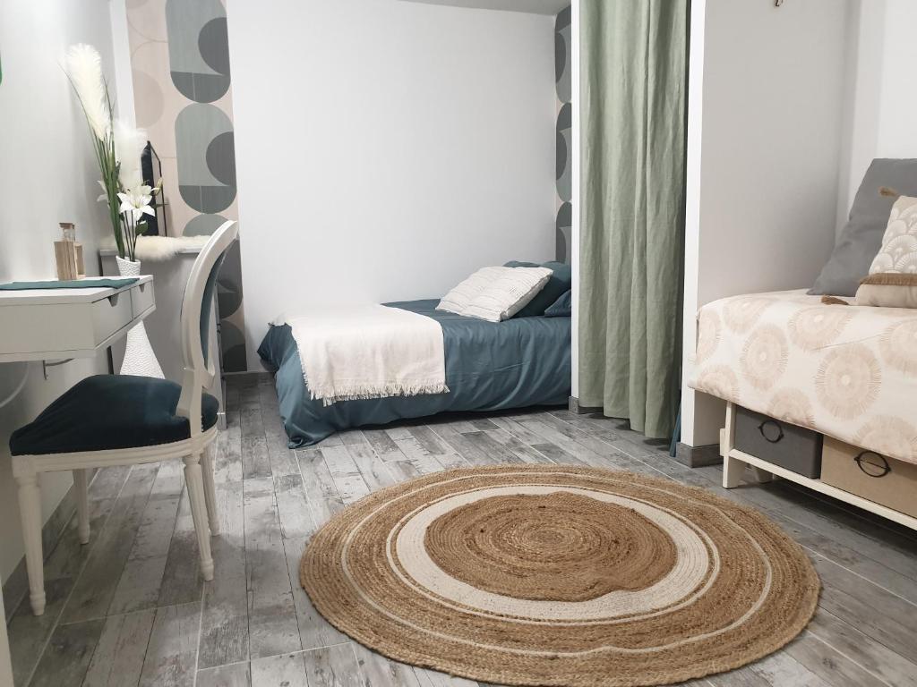 a room with a bed and a rug on the floor at La green in Brétigny-sur-Orge