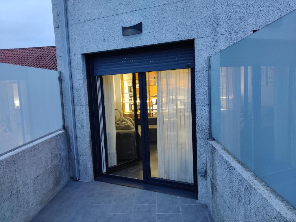 a sliding glass door on a building at Dena-Sol in Meaño