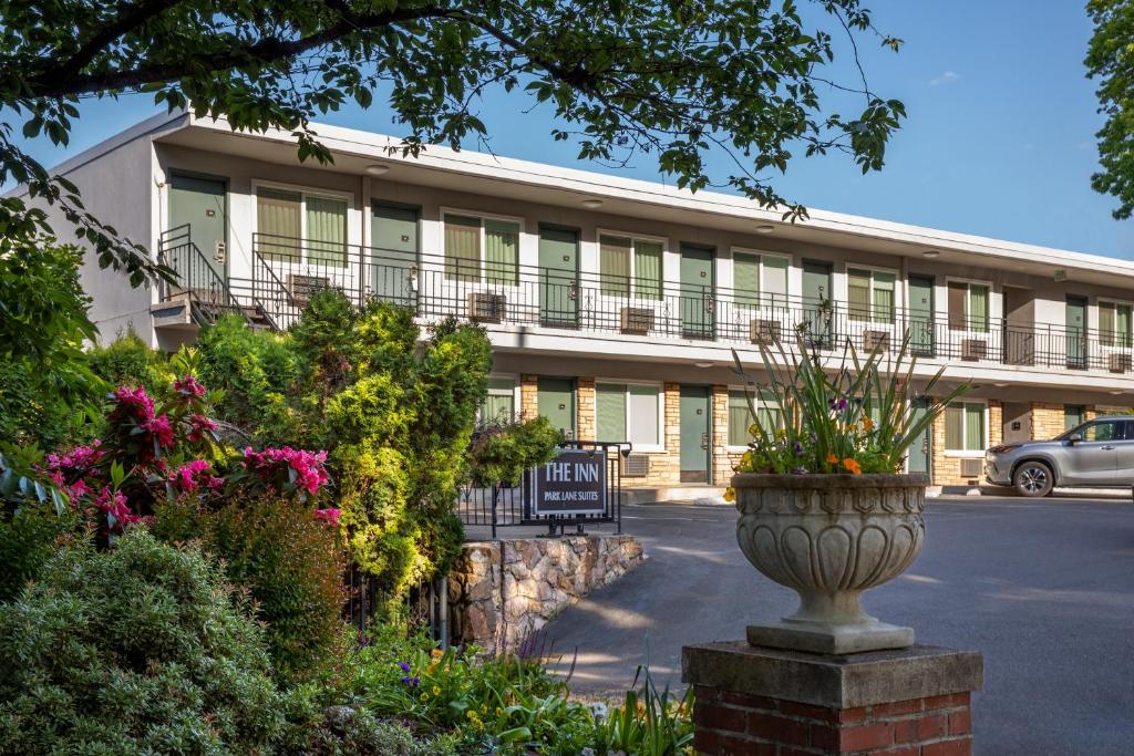 a building with a flower pot in front of it at Park Lane Suites & Inn in Portland