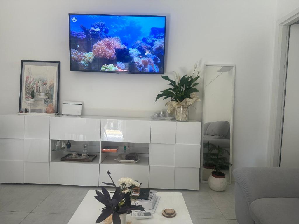 a living room with a fish tank on the wall at Pash apartment in Pero