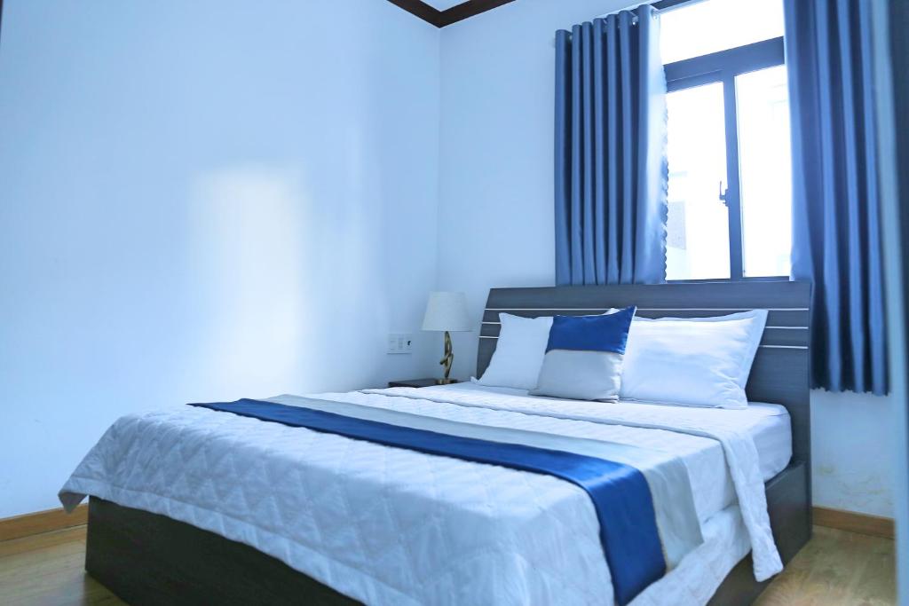 Postel nebo postele na pokoji v ubytování QV Manor Homestay