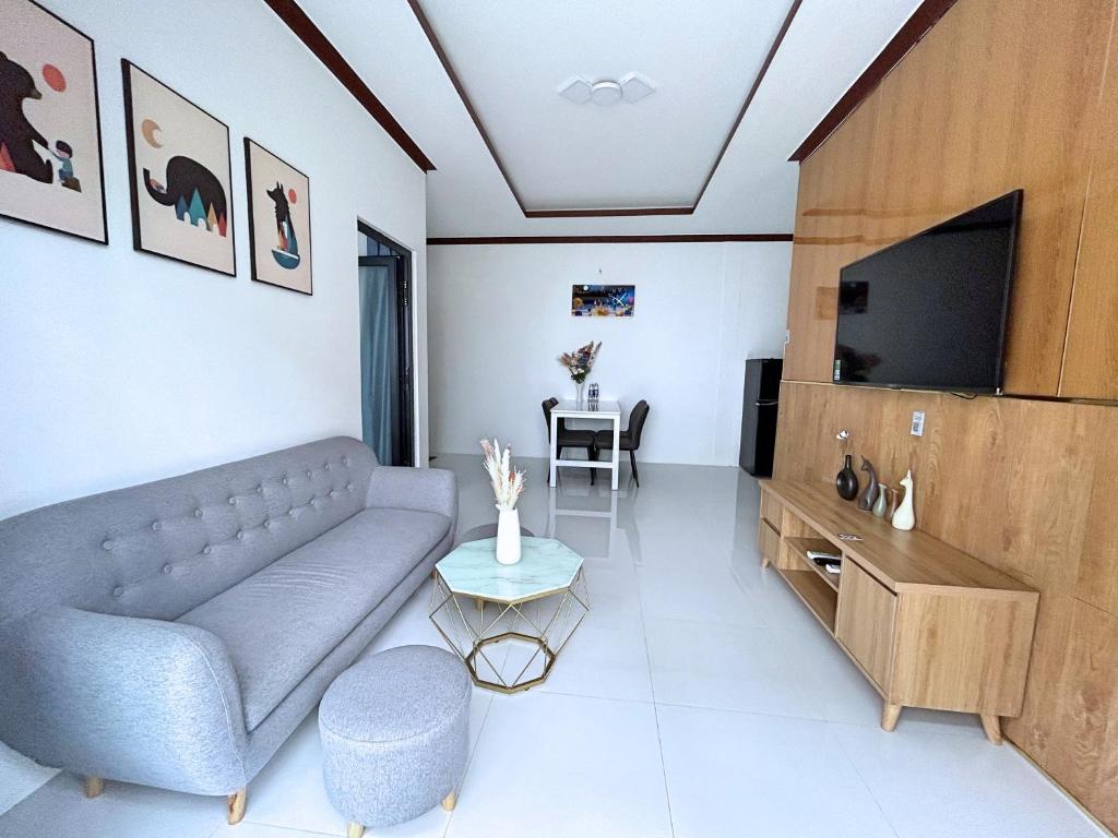 a living room with a couch and a tv at QV Luxury Apartment in Phan Rang