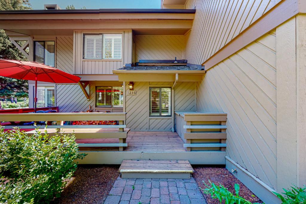 a house with stairs and an umbrella in front of it at Villager Retreat in Sun Valley