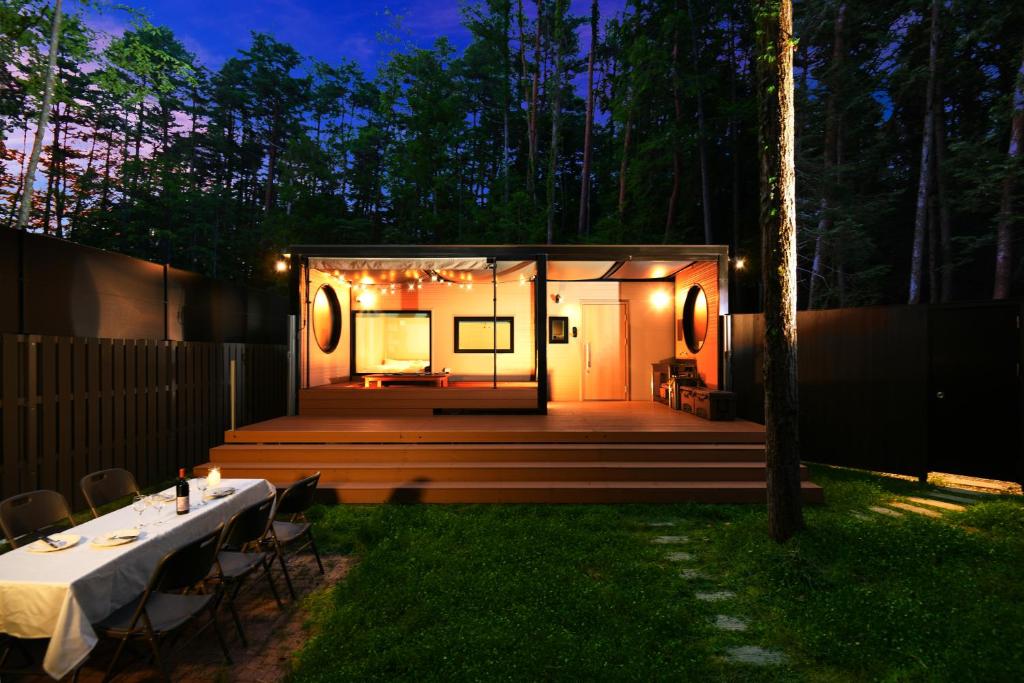 a tiny house in the woods at night at Fuji Fumoto Forest Hotspring in Fujikawaguchiko