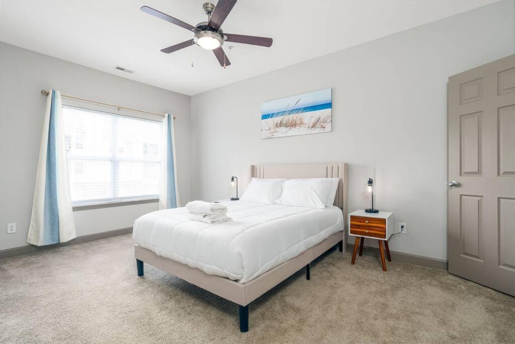 a white bedroom with a bed and a ceiling fan at Affordable 1BD Keystone in Indianapolis