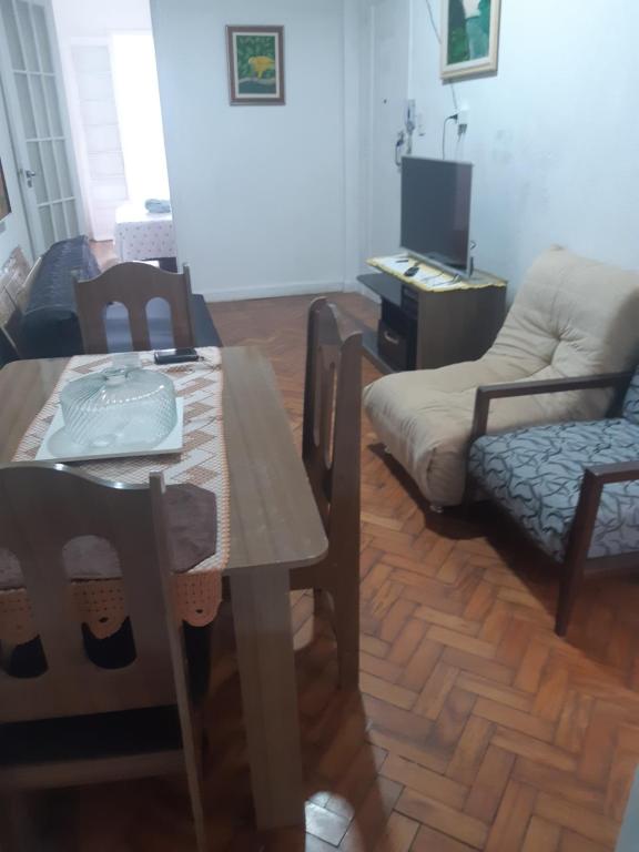 sala de estar con mesa y sofá en Apartamento Arouche, en São Paulo