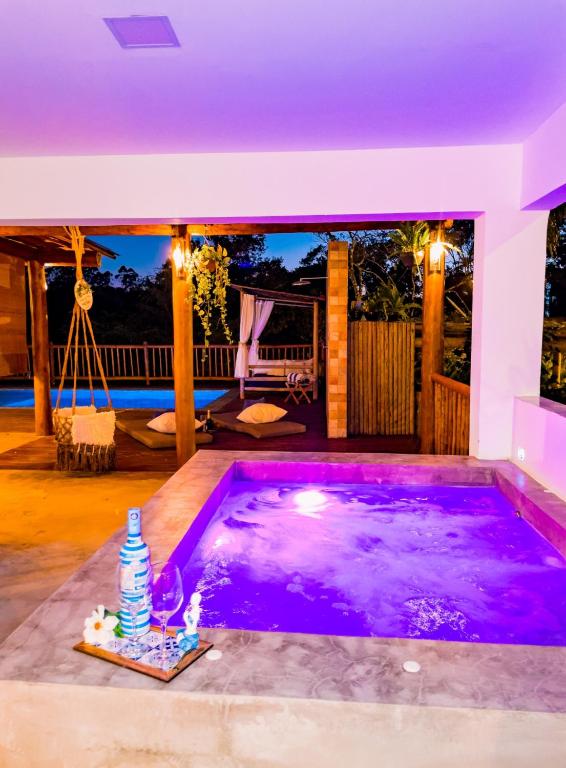 a swimming pool in the middle of a house at Casa Odara Trancoso in Trancoso