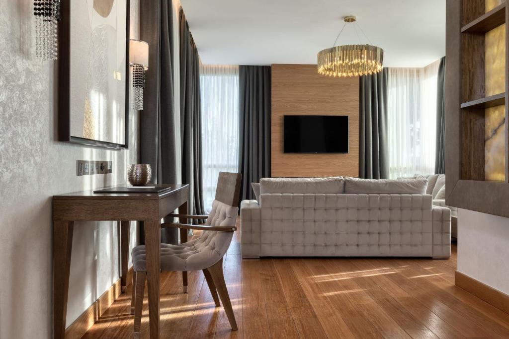 a living room with a couch and a table at Parklane, a Luxury Collection Resort & Spa, Limassol in Limassol