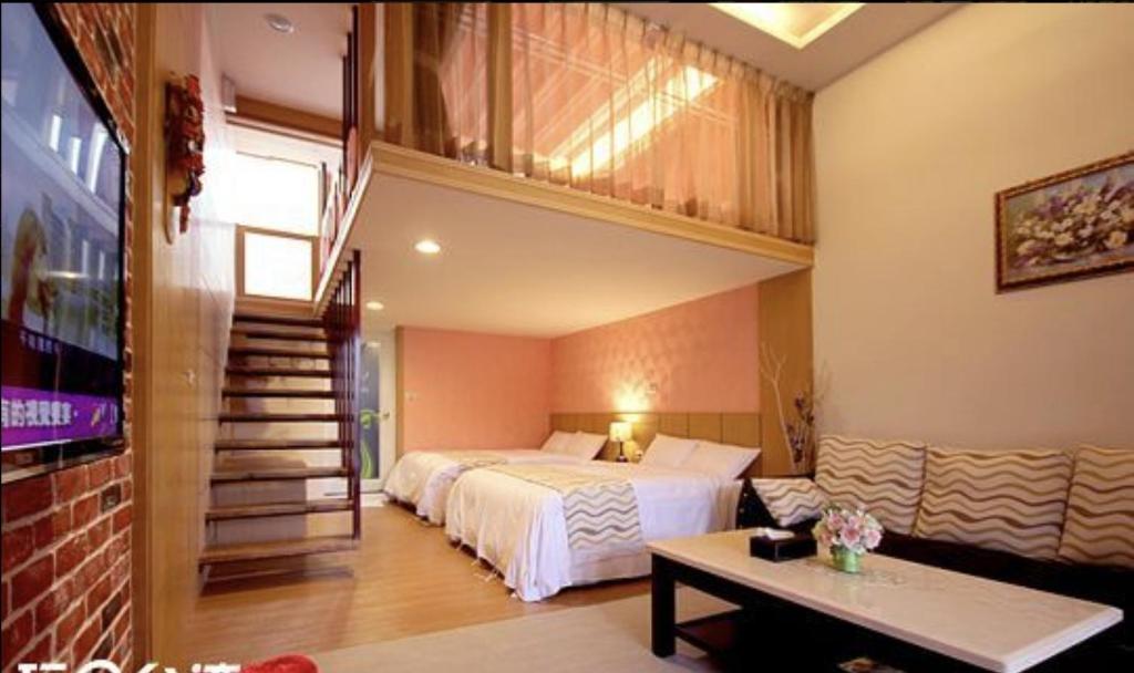 a bedroom with a large bed and a staircase at 水社海民宿 in Yuchi