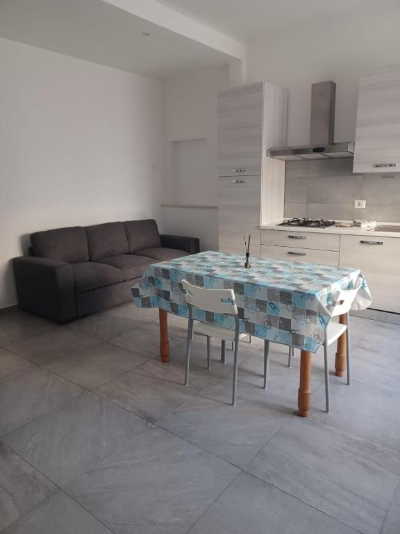 a living room with a table and a couch at Appartamento Civico Trentuno in Porto SantʼElpidio