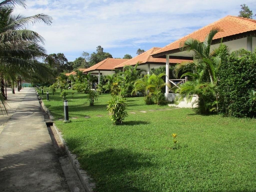 a house with a green lawn in front of it at Saracen Bay Resort in Koh Rong Sanloem