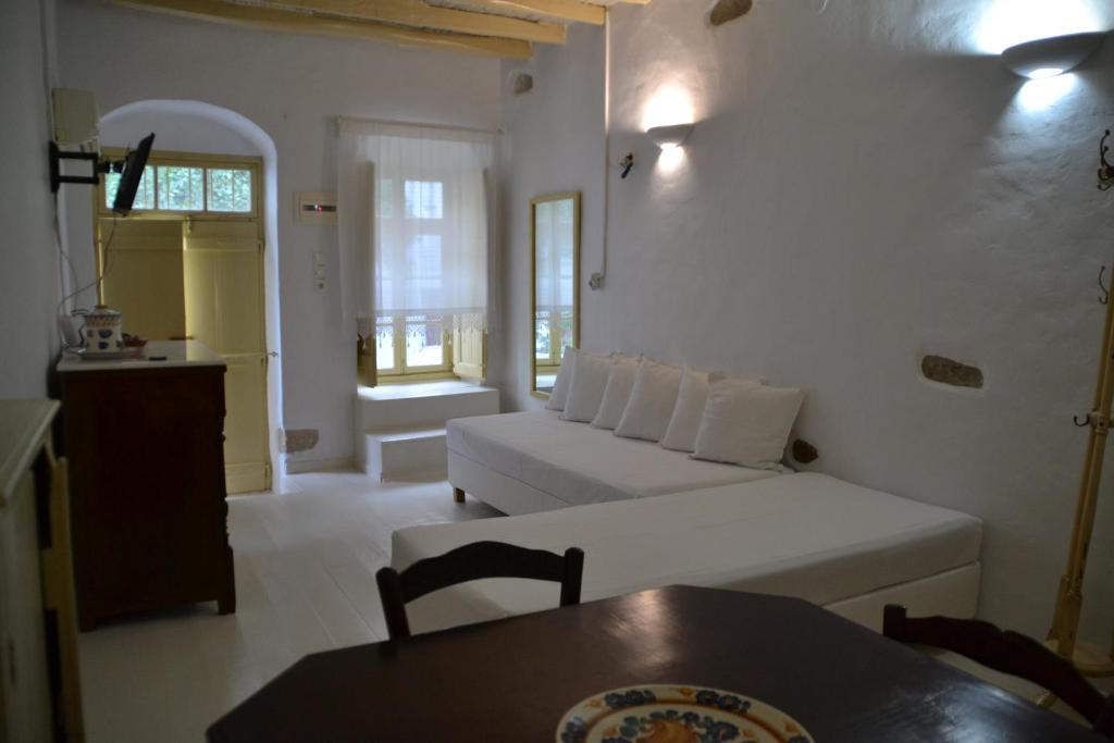 a living room with a couch and a table at Kastro in Parikia