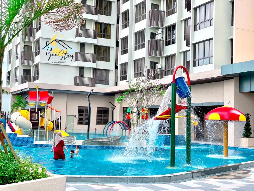a pool with a water park in front of a building at SeaView PoolView CityView BaliResidence Video game 5minJonker in Melaka