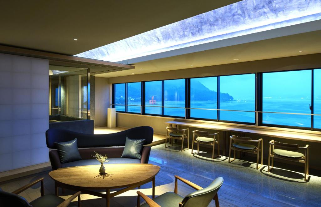 a hotel lobby with a bar with a view at 厳島いろは in Miyajima