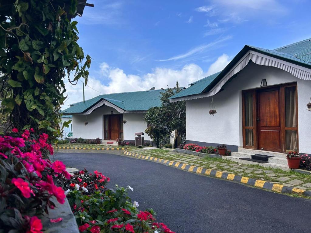 a house with flowers on the side of a road at Deshadan Mountain Resort -The highest resort in Munnar in Munnar