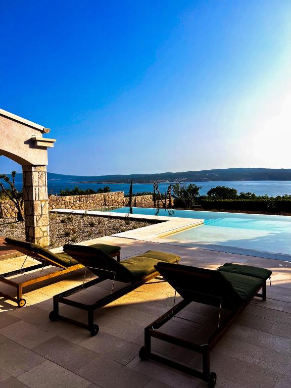 a patio with chairs and a swimming pool at Hideaway Crikvenica with Sea view and Private Pool in Crikvenica