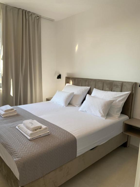 a bedroom with a large bed with two towels on it at Private Room Belmar Mandre in Mandre