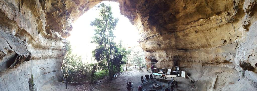 a group of people standing inside of a cave at Hatter's Hideout Cave and Lodge in Newnes Junction