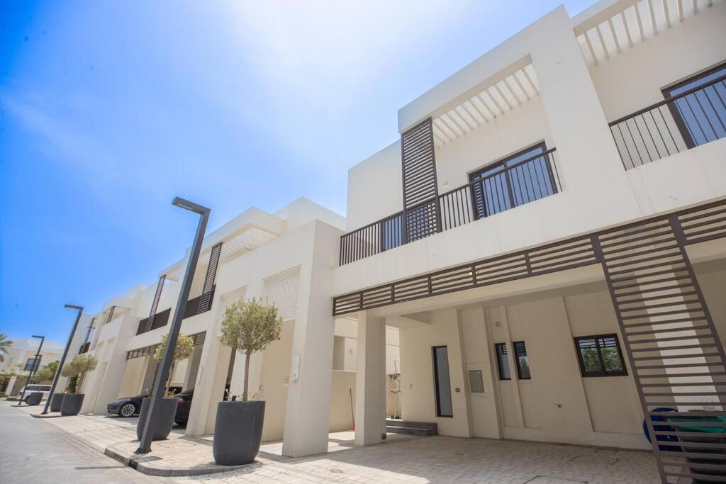 a white building with a street light in front of it at Luxury 3 bdr Villa by the sea 54 in Fujairah
