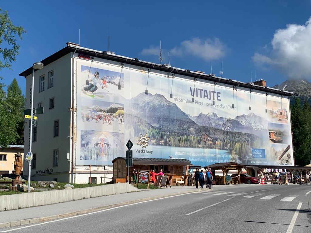 a large billboard on the side of a building at Turistická ubytovňa SHB ,Štrbské Pleso - Vysoké Tatry in Štrbské Pleso