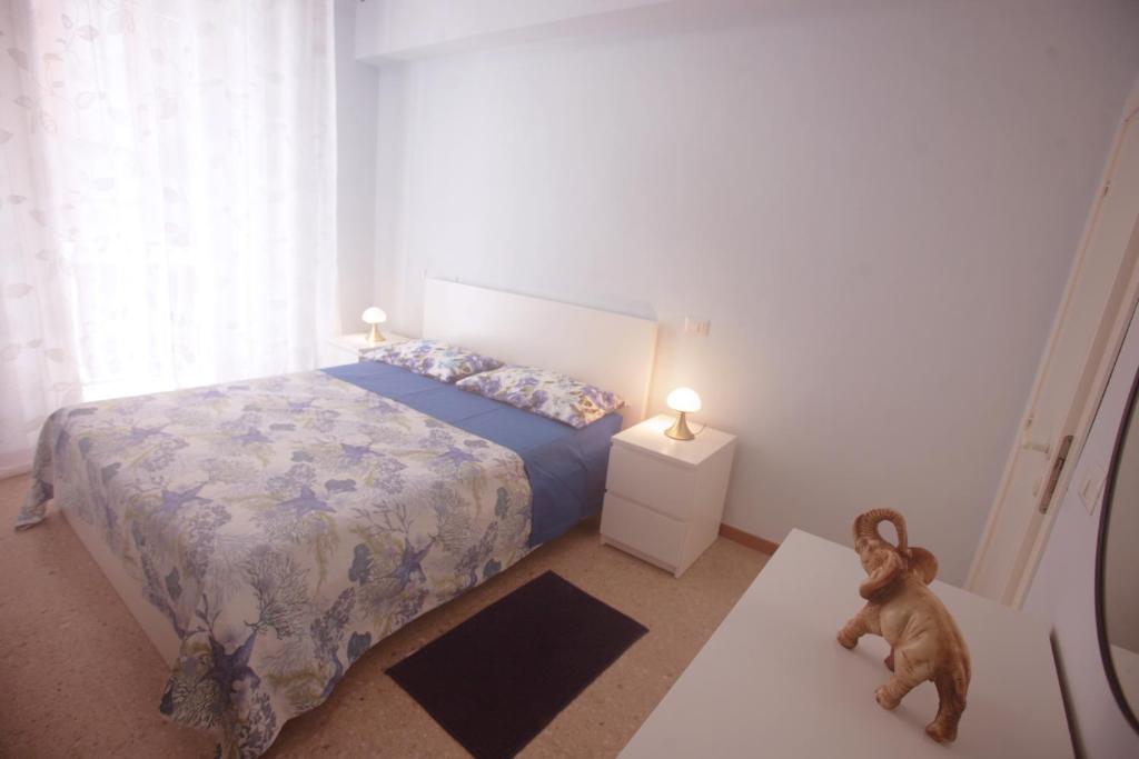1 dormitorio con 1 cama y un osito de peluche en el suelo en al mare, en Porto Recanati